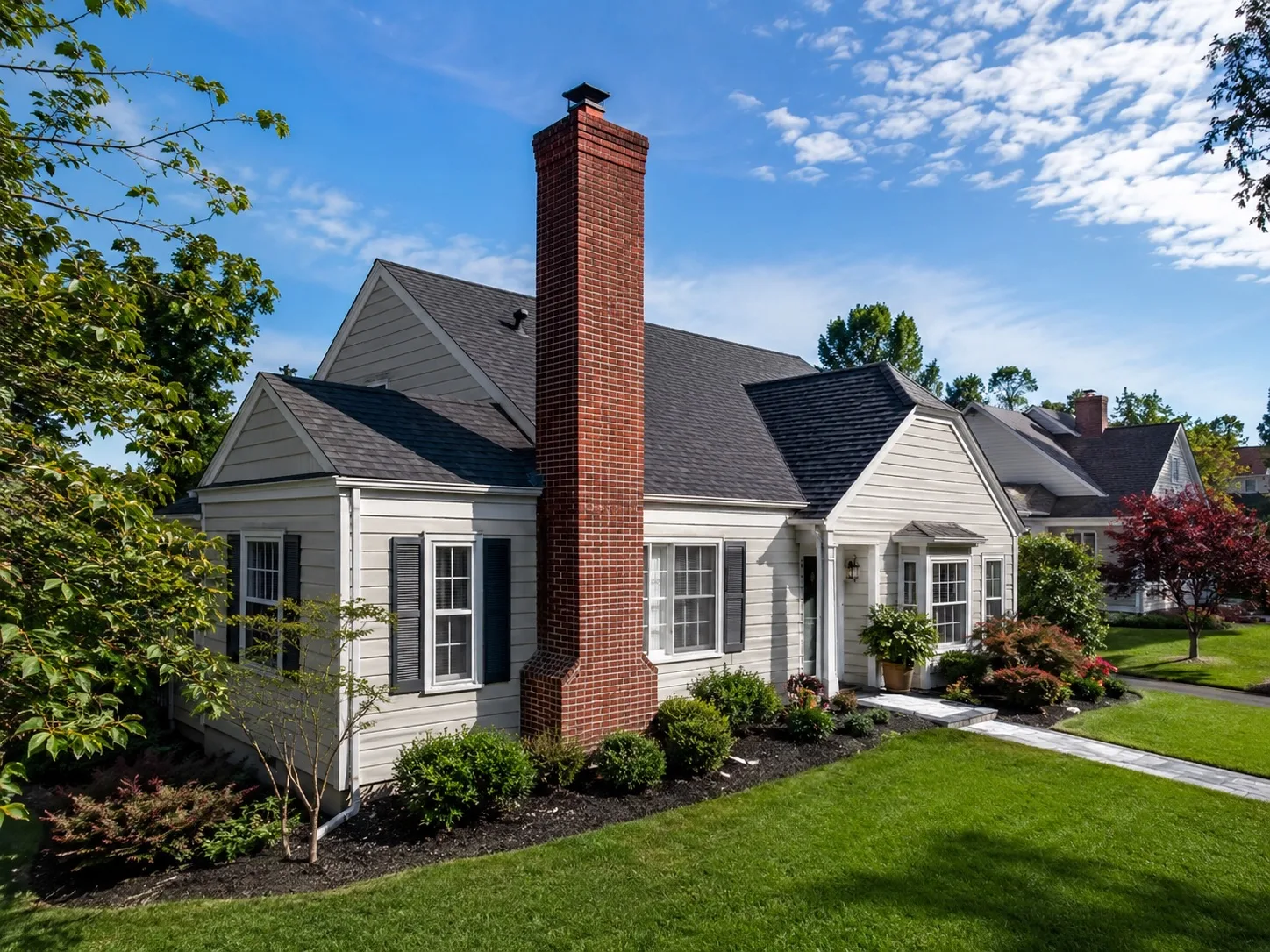 Residential home with a brick chimney against a clear sky